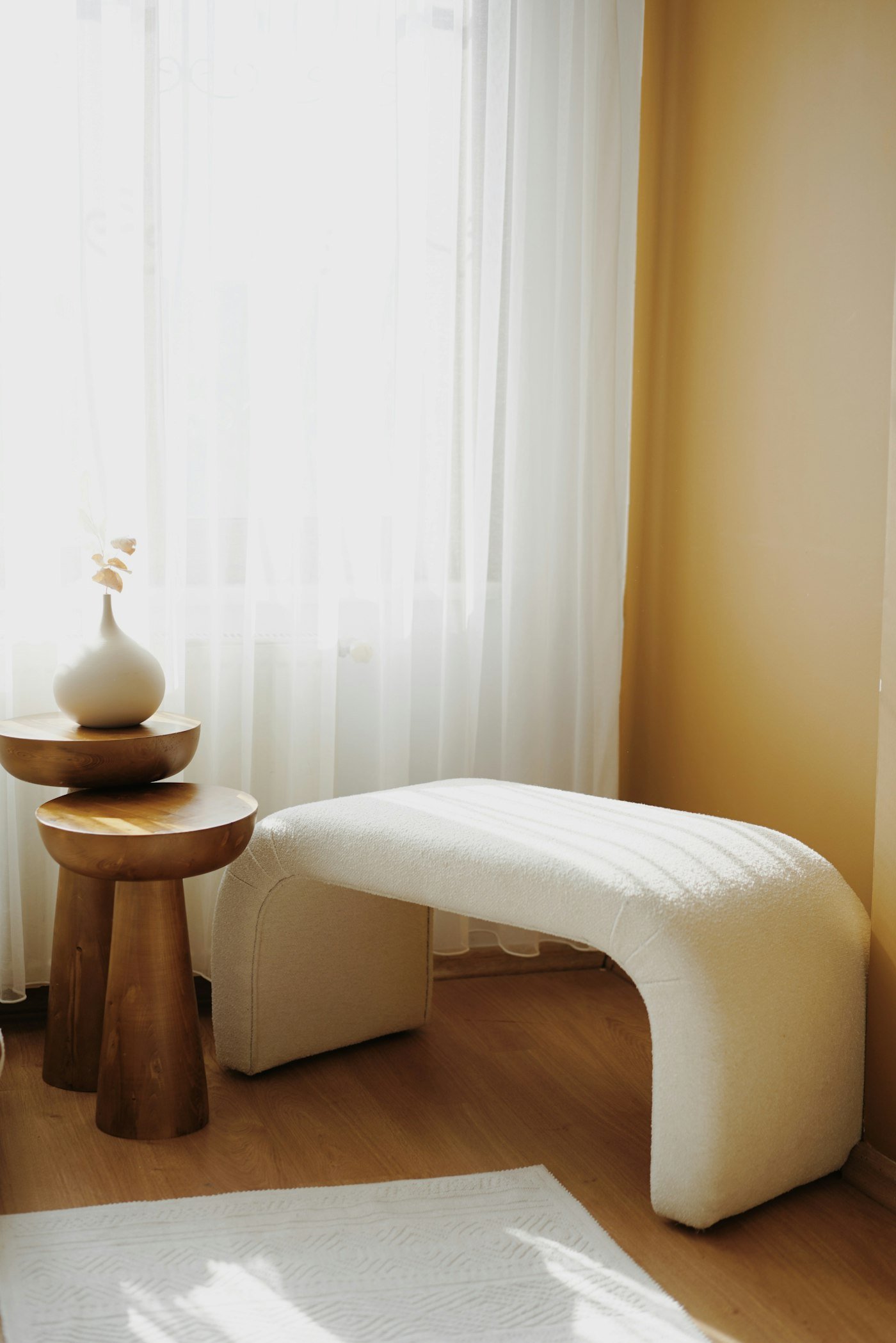A treatment room, warm light and a made bed